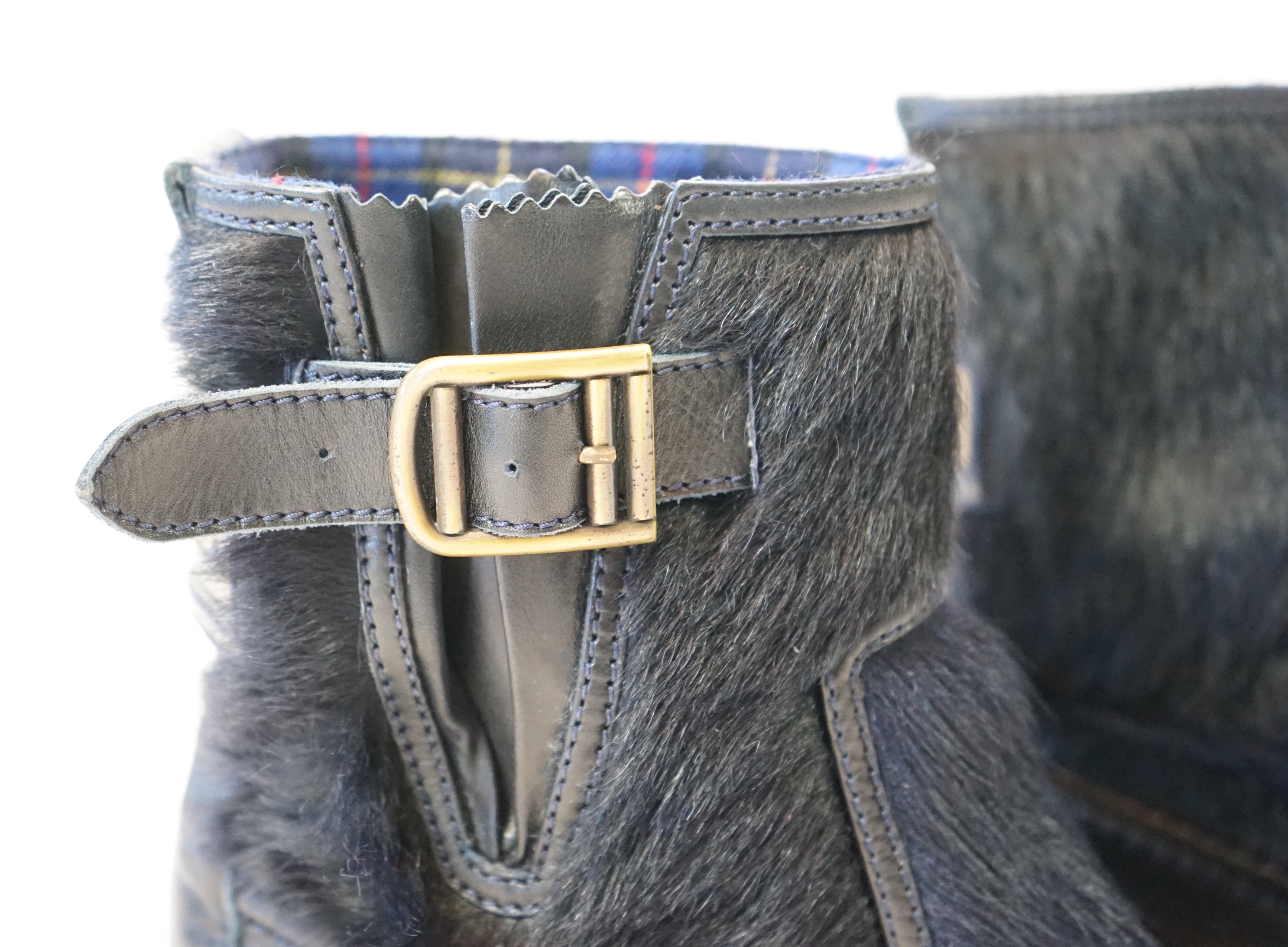 A pair of Chanel lady's navy blue leather calf hair pleated belted buckle boots, size EU 40.5